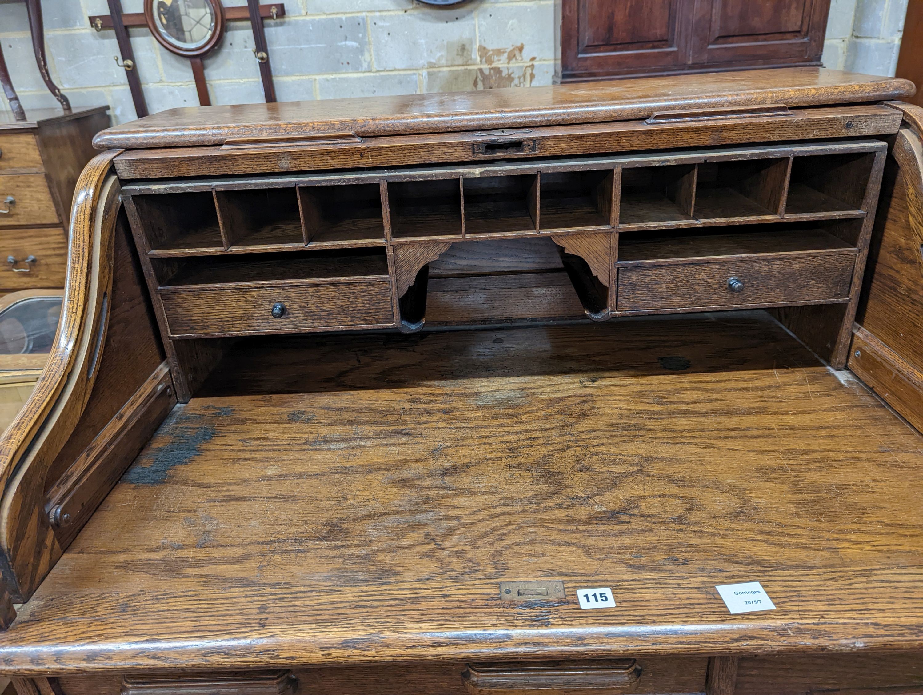An early 20th century oak roll top desk with 'S' shaped tambour, width 106cm, depth 75cm, height 119cm